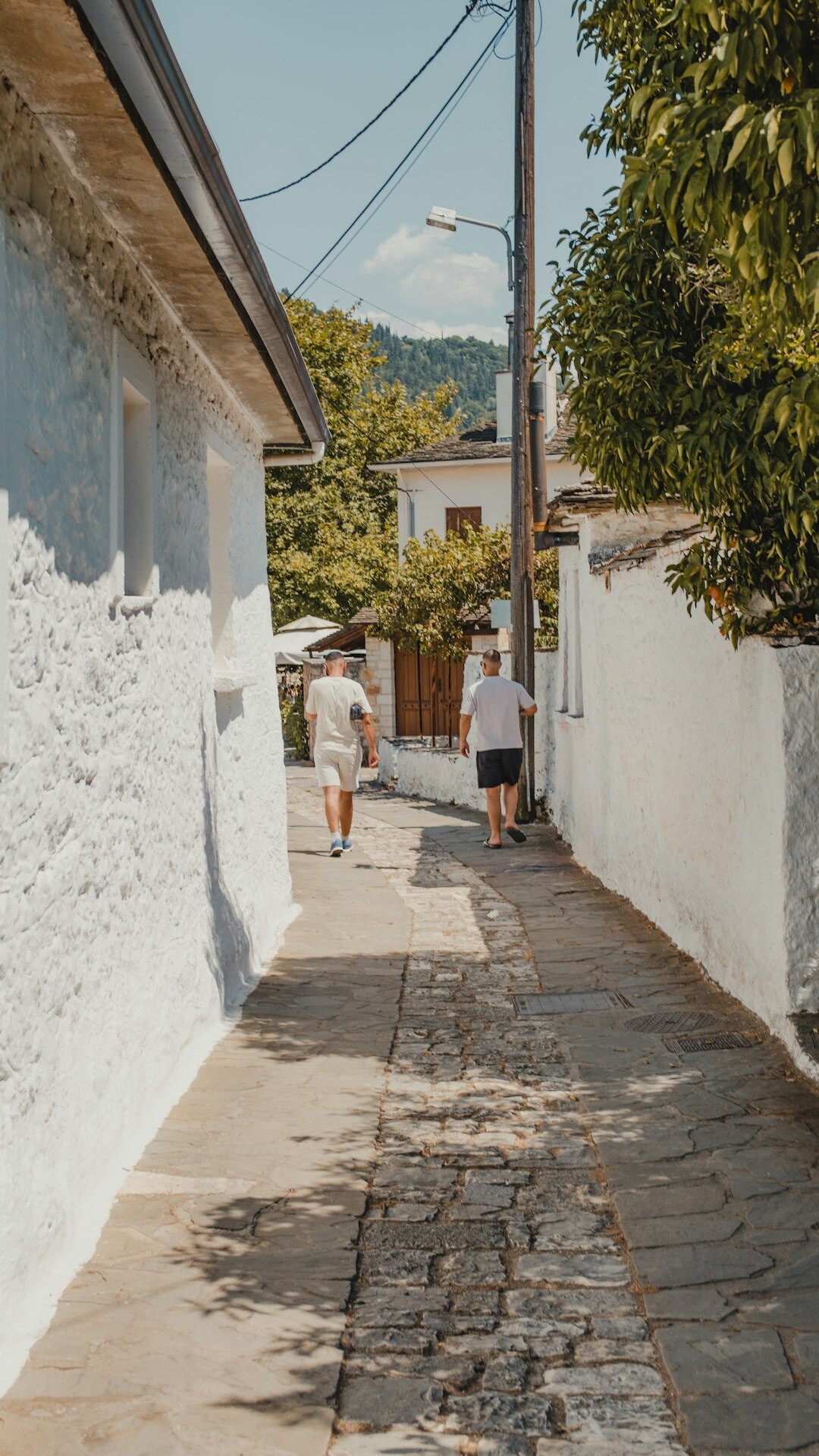 elderly couple walking in village street