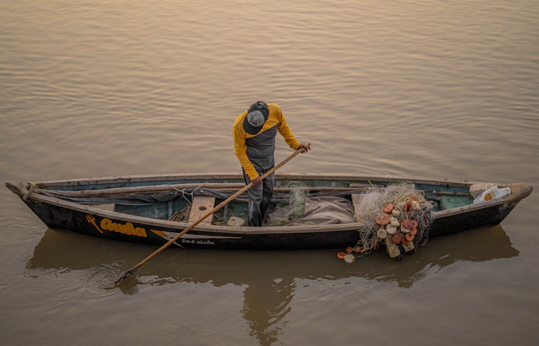 fisherman on boat at dawn
