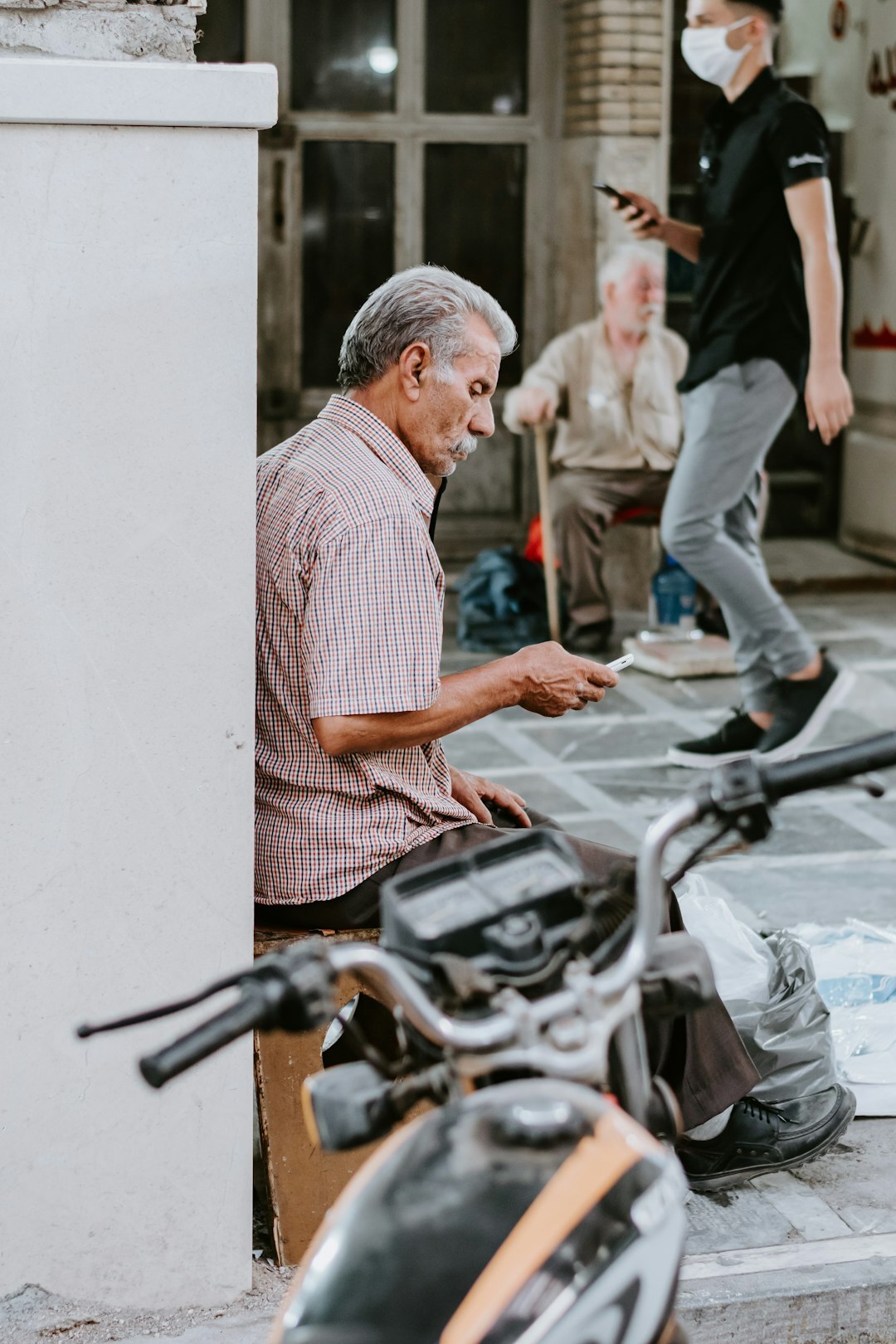 person helping elderly neighbor
