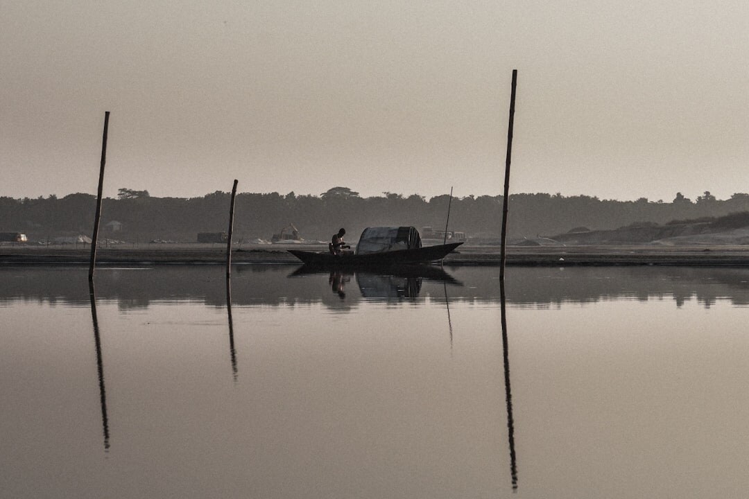 fisherman on boat at dawn